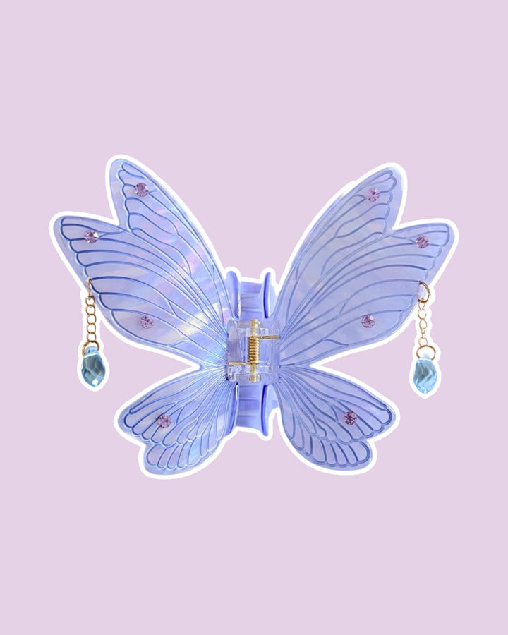 Purple fairy wings with etching details and embedded gems, with dangling gems off the sides on a purple background.