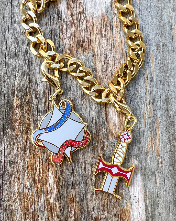 Legendborn charms featuring Excalibur and the Legendborn symbol.