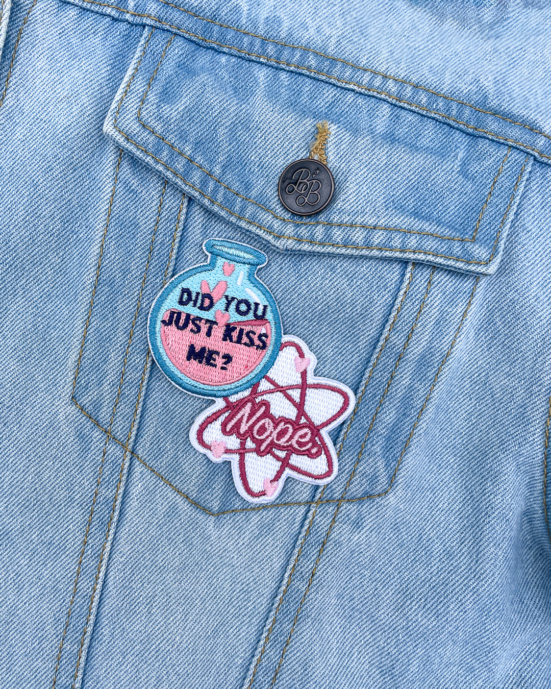 Love Hypothesis patch featuring a blue flask with pink liquid and heart bubbles with the quote &