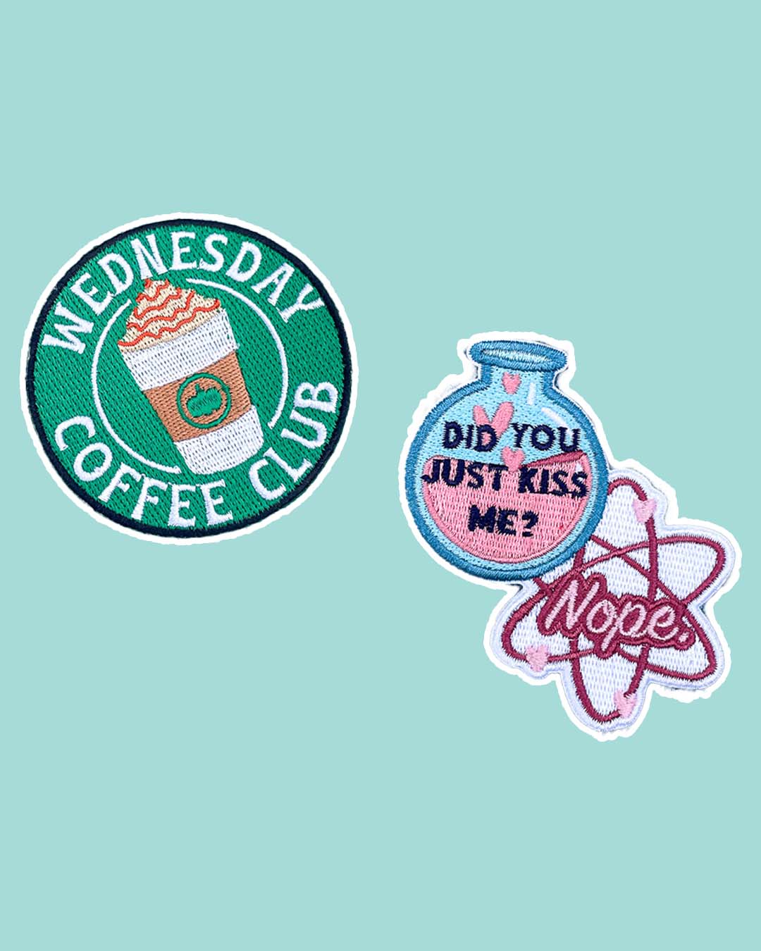 The Love Hypothesis patch set featuring a green 'Wednesday Coffee Club' patch with a to-go coffee cup in the center and a blue and pink flask and an atom design with the quote 'Did you just kiss me? Nope' on them.