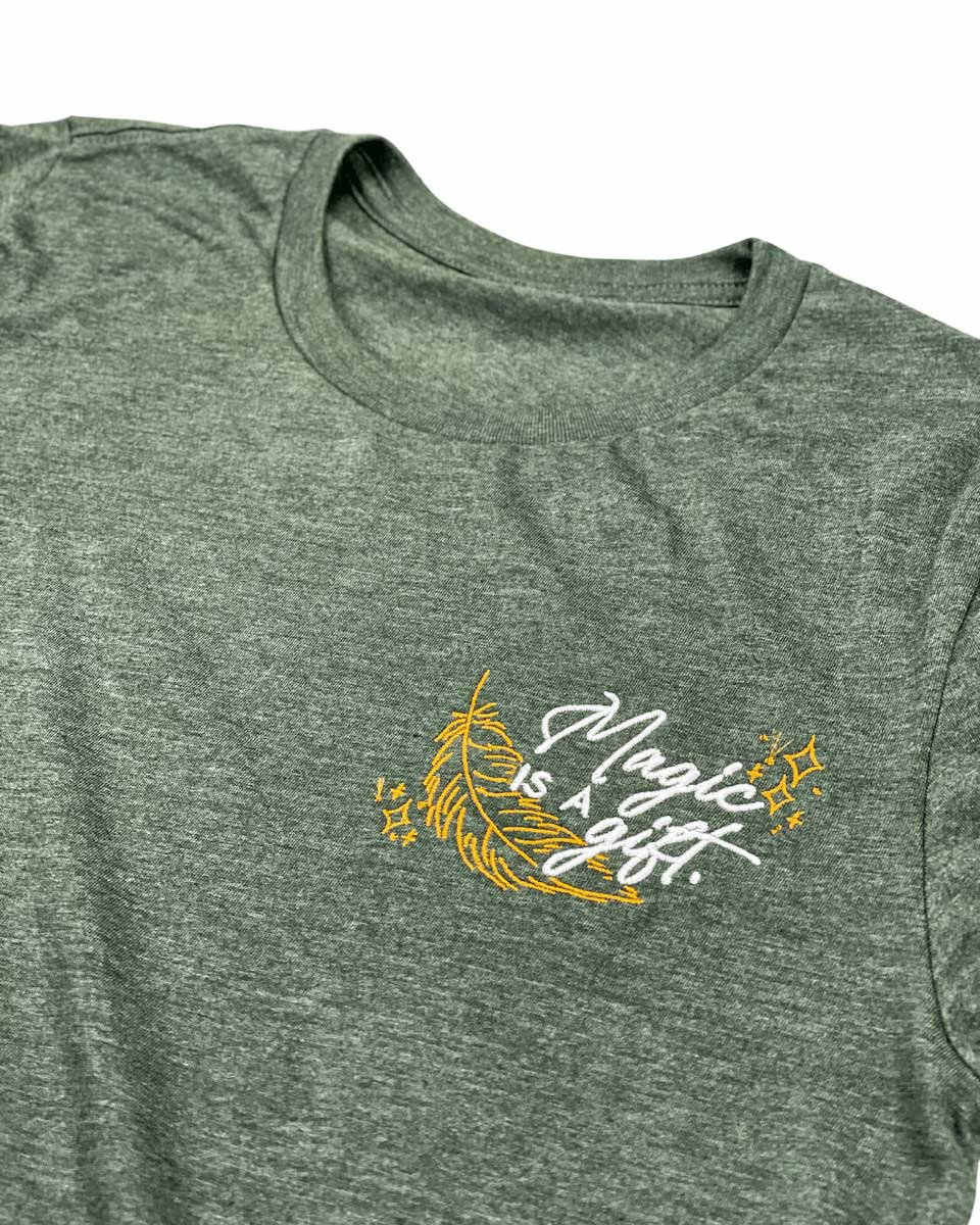 Wild is the Witch embroidered tee featuring a gold feather with stars and the quote &