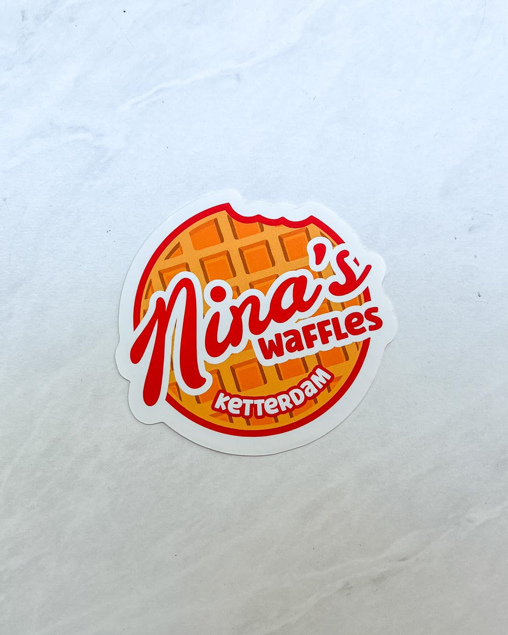 Sticker for Six of Crows fans featuring a design for 'Nina's Waffles' in Ketterdam.