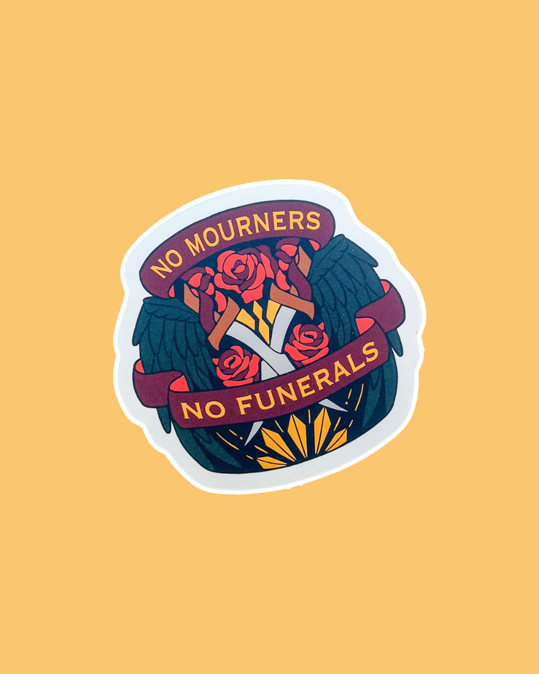 Six of Crows sticker for Leigh Bardugo fans featuring the iconic phrase 'No Mourners, No Funerals,' roses, two crossed, swords, and wings.