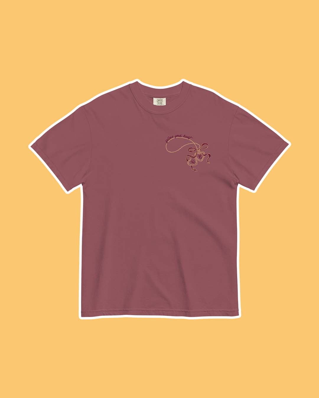 Phantasma shirt featuring a printed design of Ophelia's locket open with an 'O' and 'B' inside with a bow tied around the gold chain.