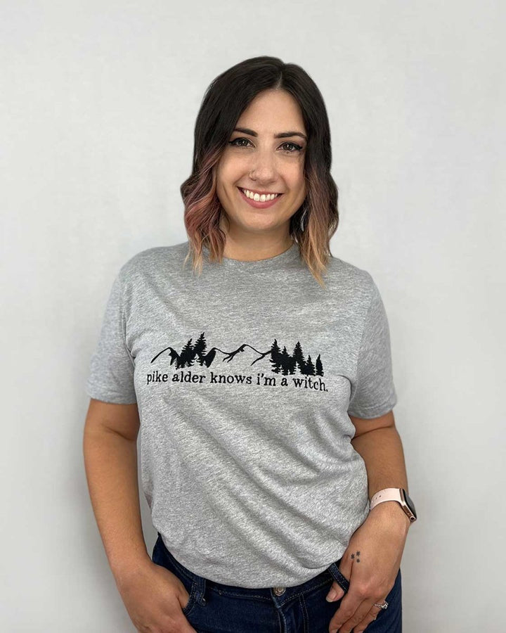 Rachel Griffin shirt for Wild is the Witch fans featuring a black-lined design of mountains and pine trees with the phrase &