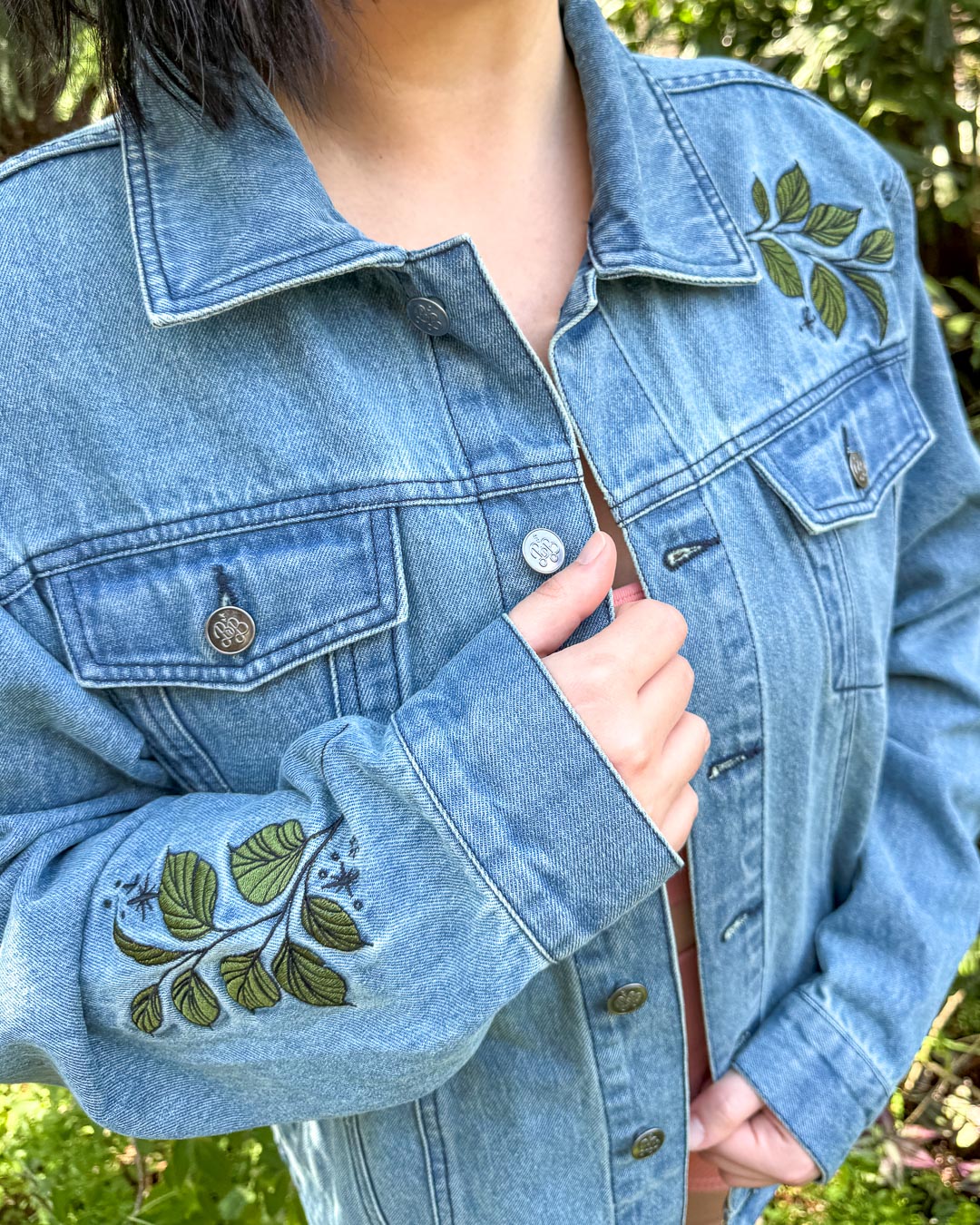 Bookish jean jacket featuring the embroidered leaves on the sleeve and shoulder.