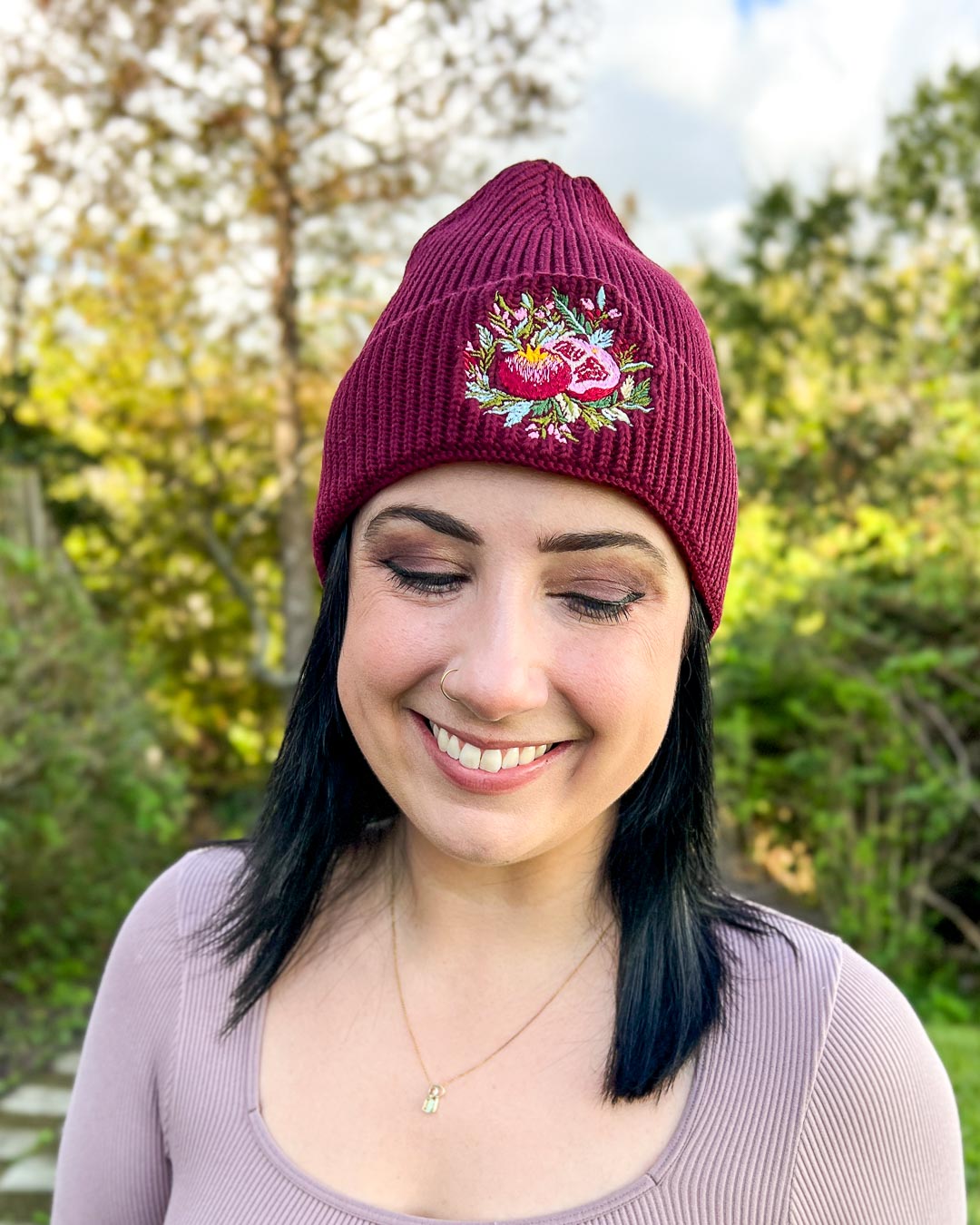Fantasy hat for Hades and Persephone fans with an embroidered pomegranate on a rib knit beanie.