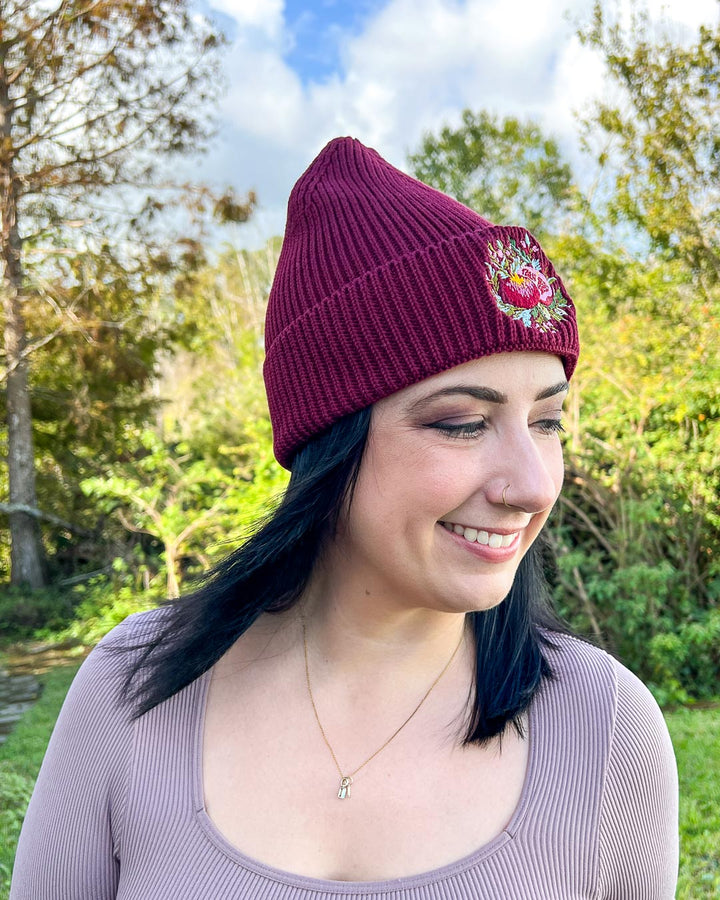 Pomegranate beanie for myth fans featuring an embroidered pomegranate.