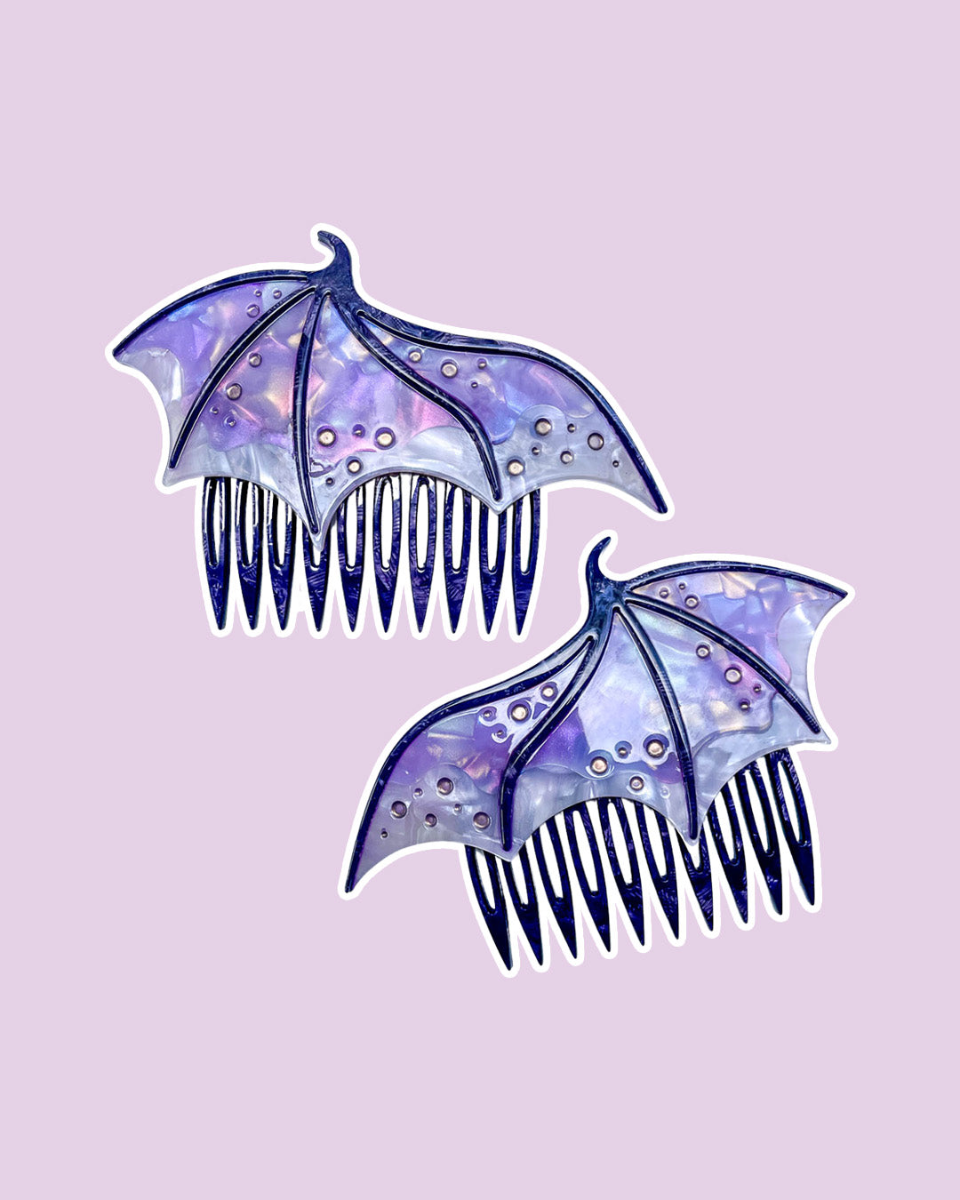 Dragon wing hair combs for fantasy fans in purple featuring engraved embellishments and a pearlescent purple color.