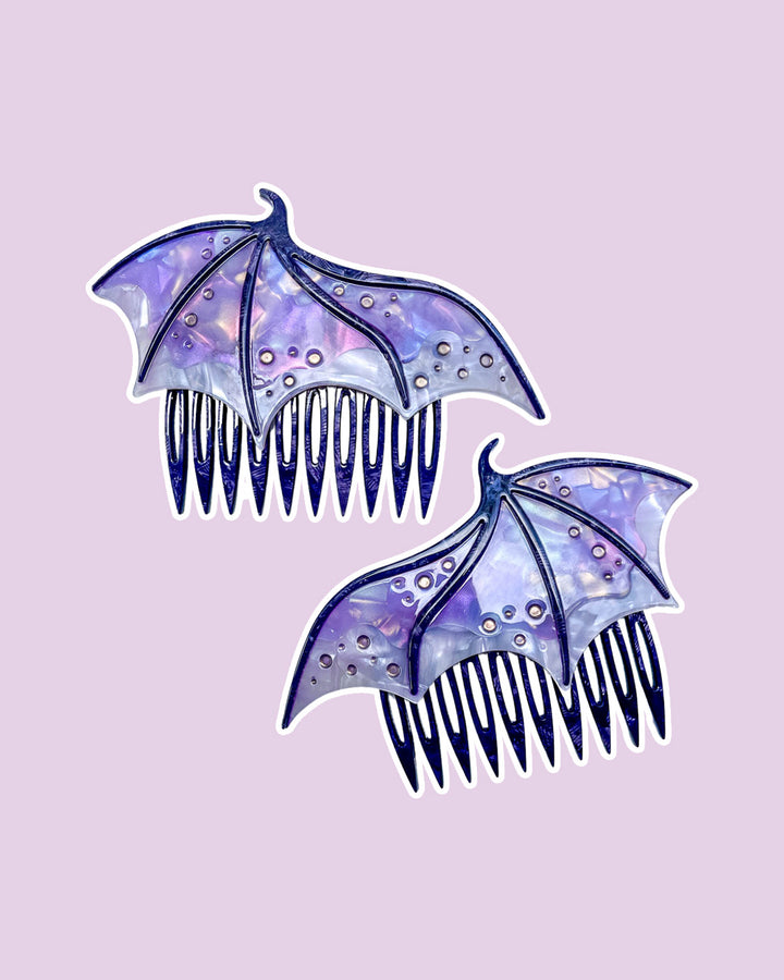 Dragon wing hair combs for fantasy fans in purple featuring engraved embellishments and a pearlescent purple color.