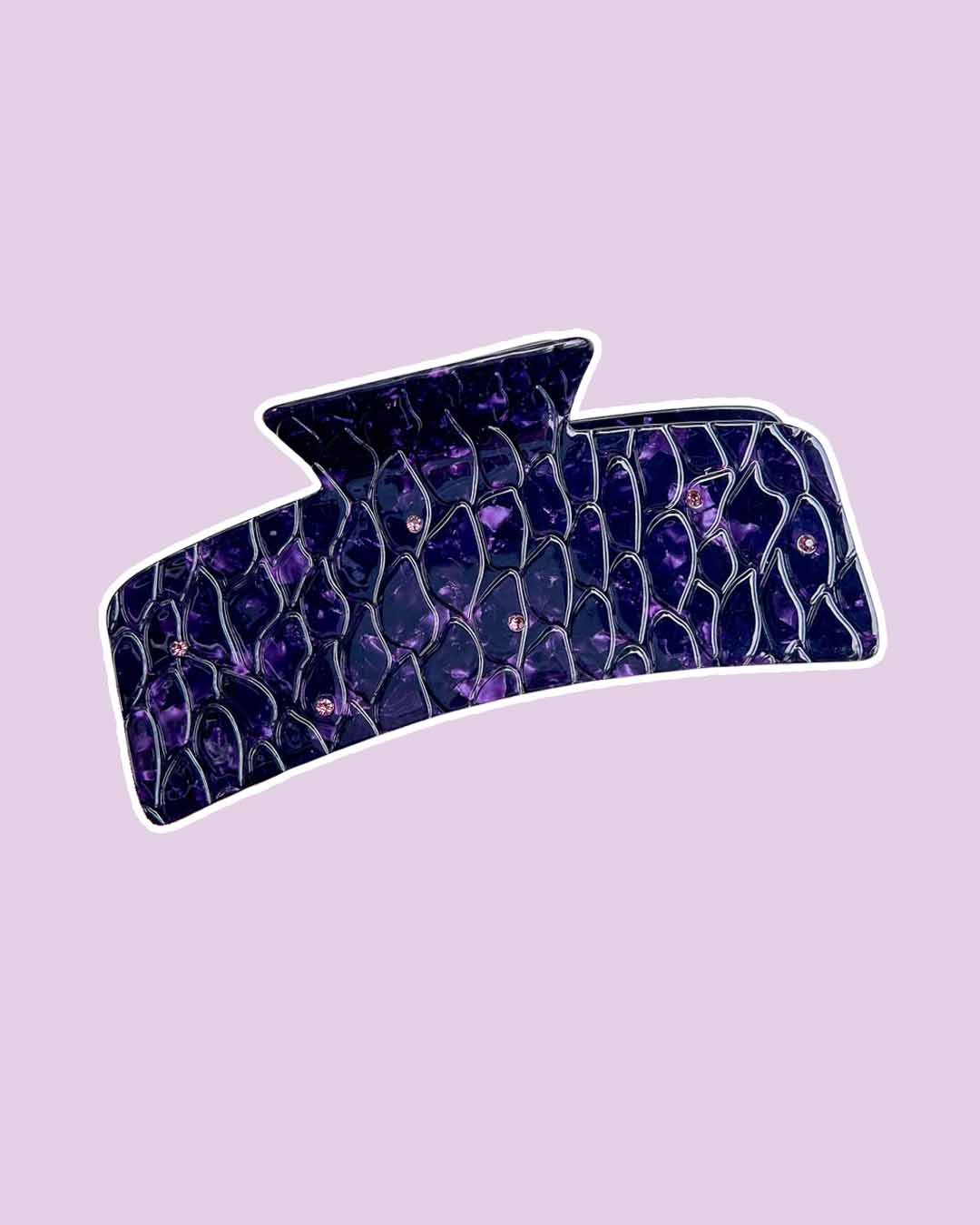A fantasy hair claw clip crafted in a dual-tone purple pearlescent swirl accented by dark purple gems designed to look like dragon scales.