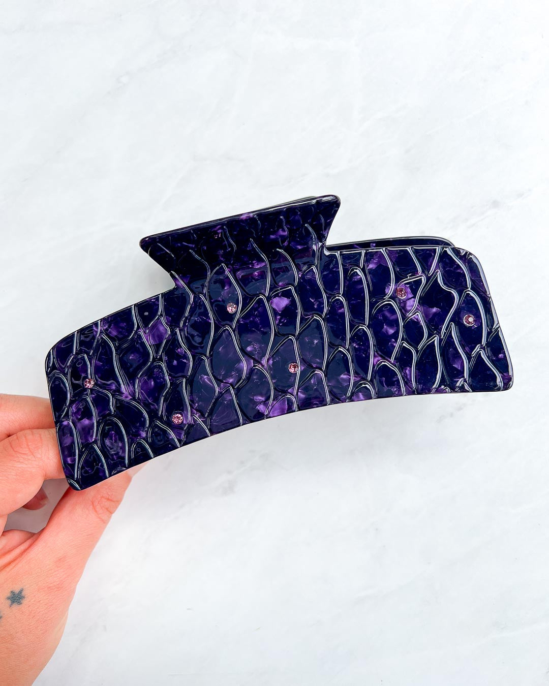 XL dragon scale hair clip for fantasy readers with a dual-tone purple pearlescent swirl design and dark purple gem embellishments.