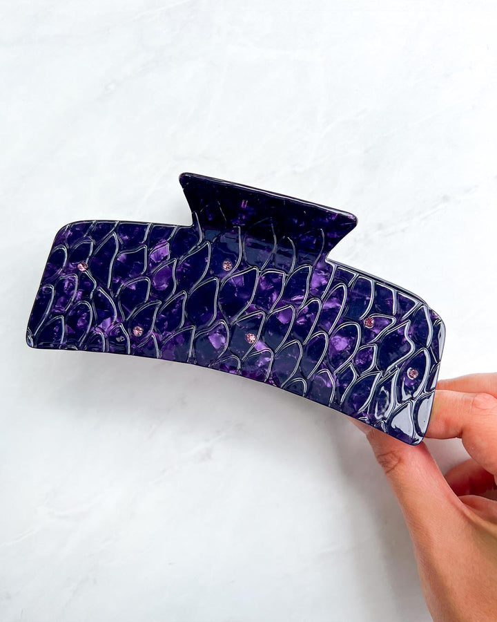 Large dragon scale hair claw clip for fantasy lovers with gem embellishments and a purple pearlescent swirl design.