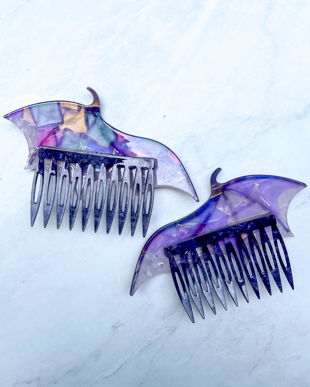 Back of the dragon wing hair accessories featuring a set of purple hair combs and a pearlescent color.