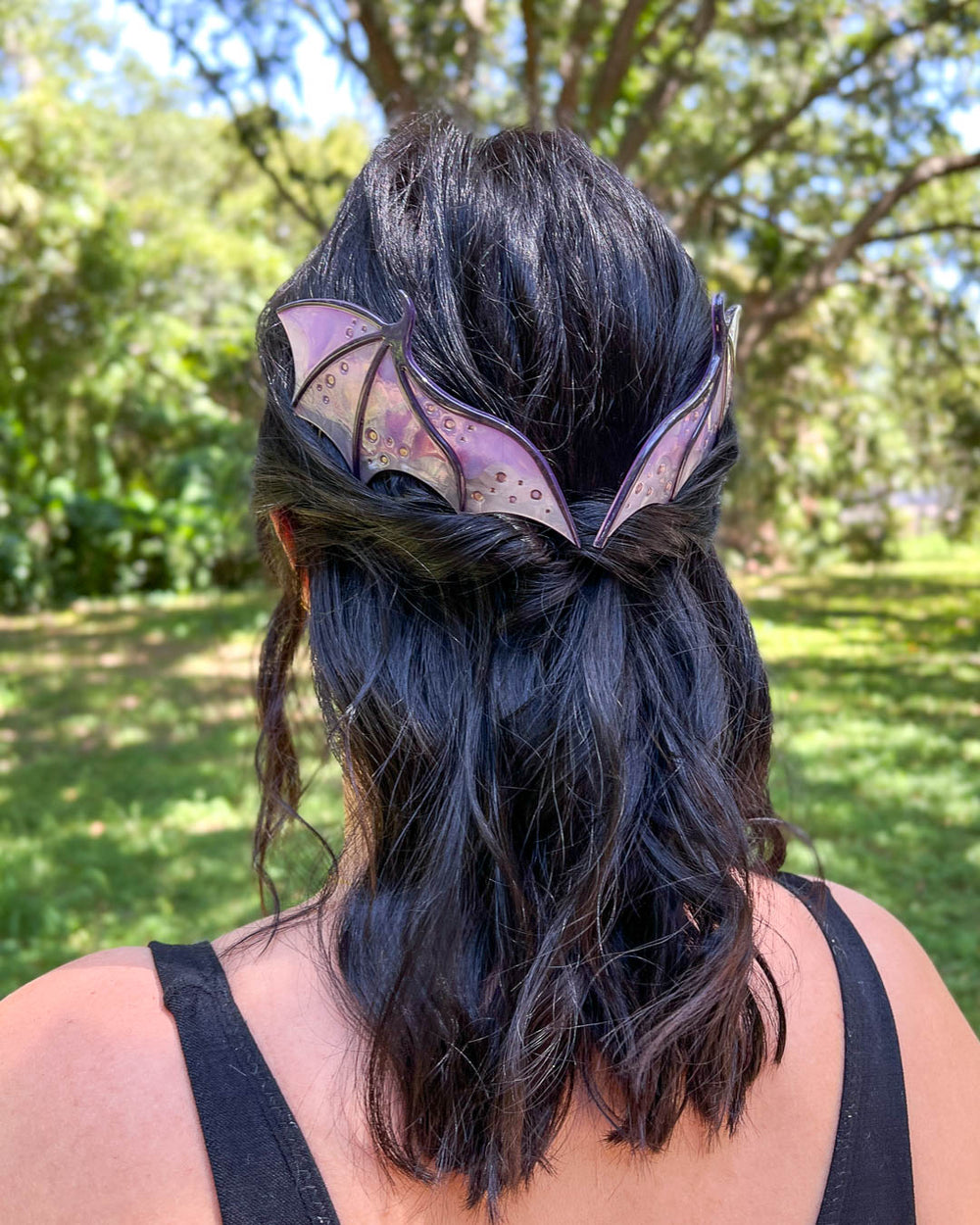 Dragon hair combs with engraved embellishments and a purple-toned pearlescent acetate material. 