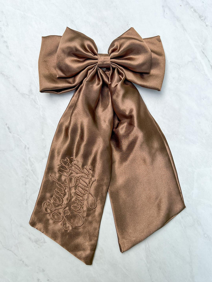 Embroidered hair bow designed in shiny brown satin with &
