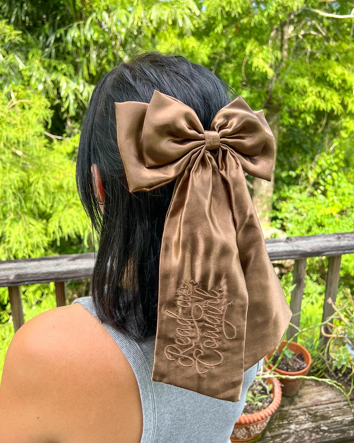 Brown hair bow for book lovers featuring the phrase &
