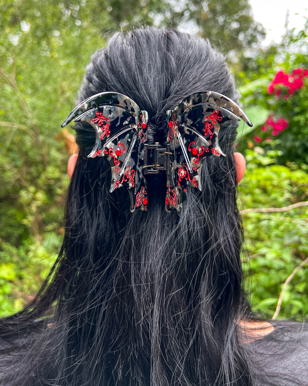 Red A Court of Thorns and Roses hair accessory with red gem embellishments and etching details.