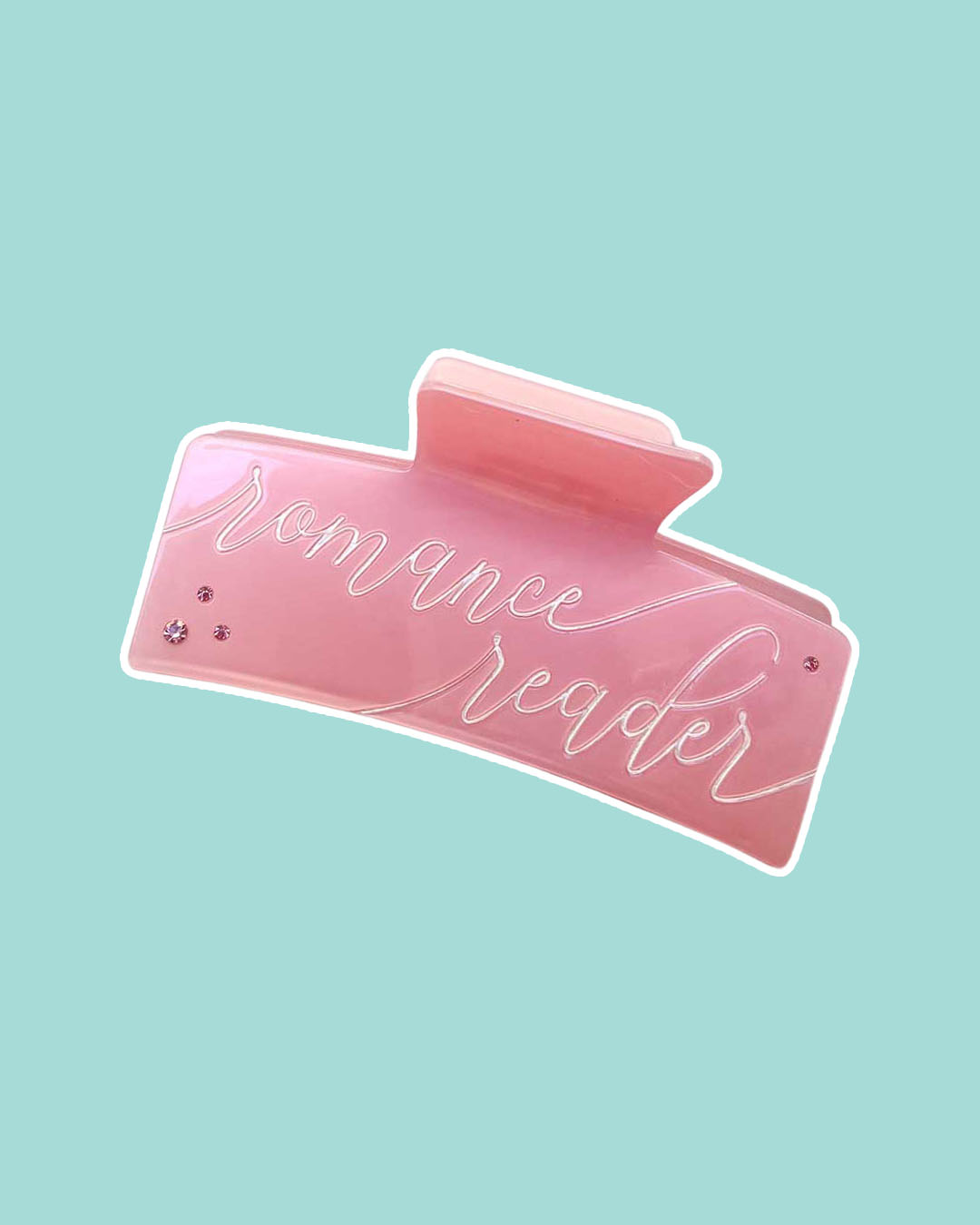 Bookish hair claw clip for romance readers featuring a light pink double-sided design with 'Romance Reader' written in script text and small gem embellishments.