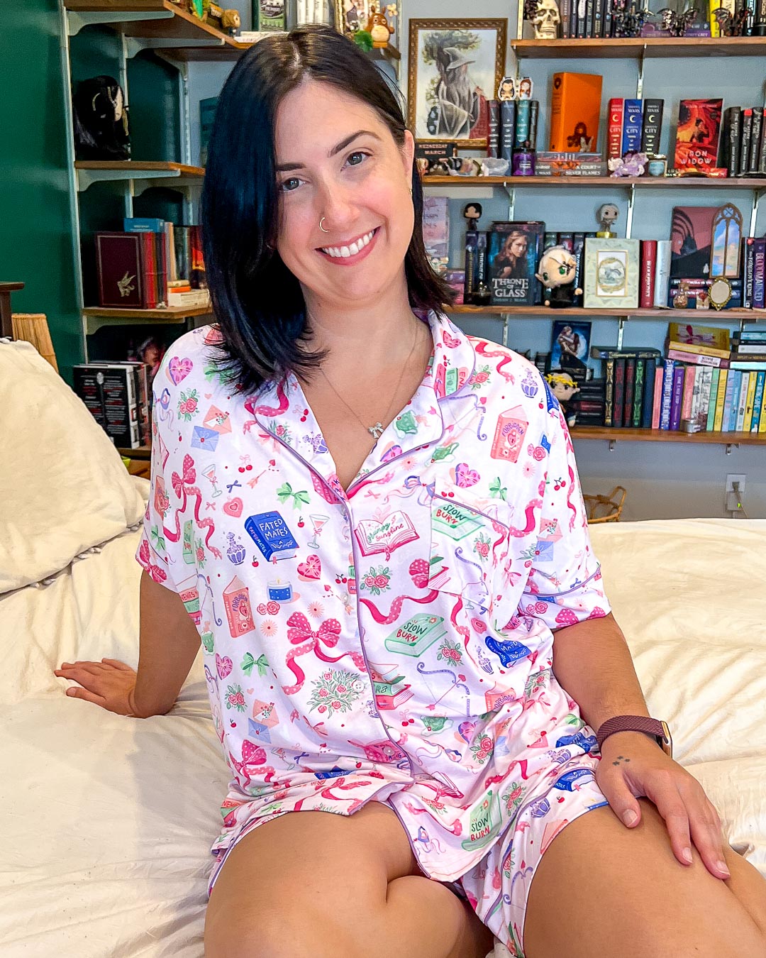 Bookish pjs set for romance readers with a cute illustrated pattern of bows, hearts, and books with tropes on them like slow burn, enemies to lovers, fated mates, and more.