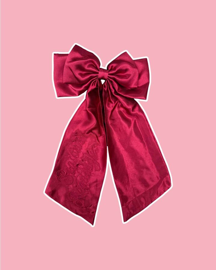 Red satin hair bow clip with the phrase &