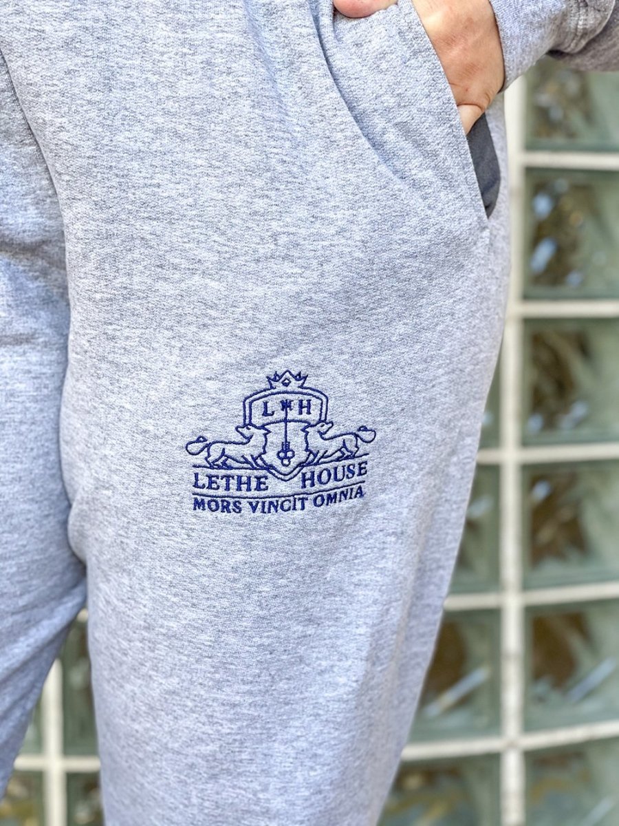 Close up of the embroidered joggers for Ninth House fans featuring a logo for Lethe House and &