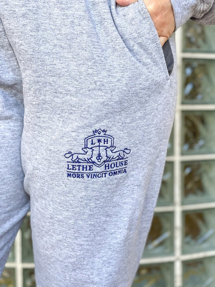 Close up of the embroidered joggers for Ninth House fans featuring a logo for Lethe House and &