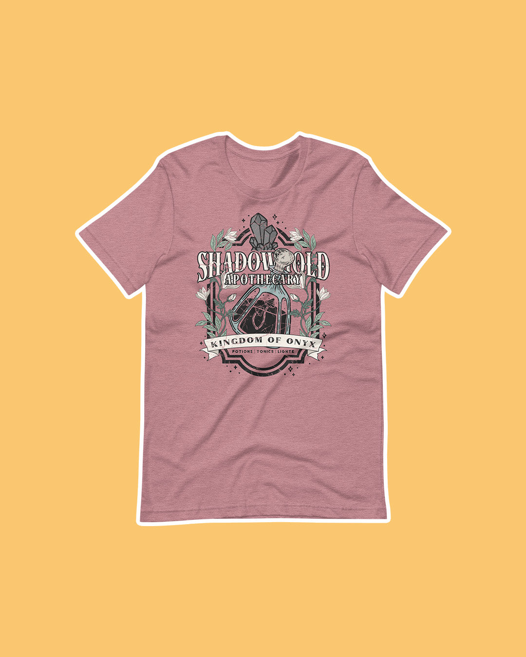 A Dawn of Onyx shirt for fantasy fans featuring a design for the Shadowhold Apothecary embellished with flowers, a potion, gems.