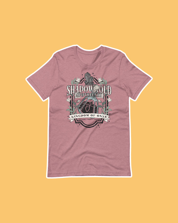 A Dawn of Onyx shirt for fantasy fans featuring a design for the Shadowhold Apothecary embellished with flowers, a potion, gems.