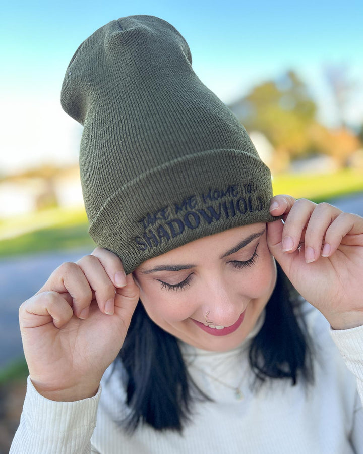 Kate Golden embroidered beanie in olive green inspired by The Sacred Stones series with the text &