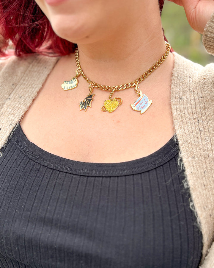 Bookish charms featuring Stalking Jack the Ripper charms of a gold locket and a mortician&