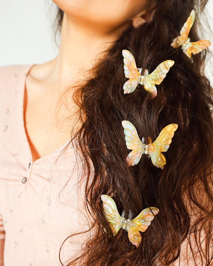 Fantasy hair claw clip for ren faire fans featuring a fairy wing design in iridescent gold acetate.