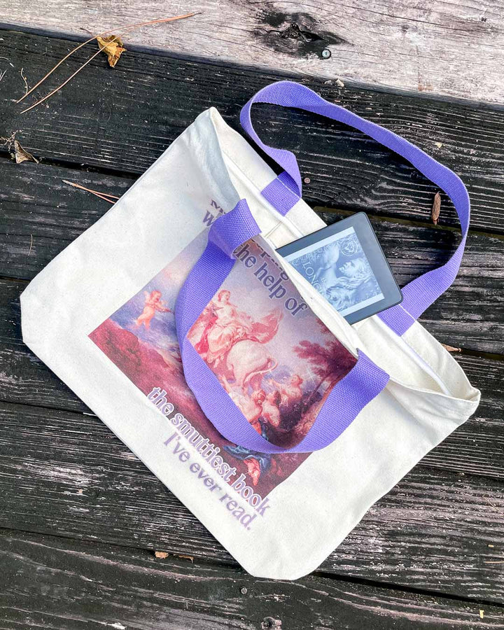 Bookish tote bag with purple straps, an inside pocket, and a zipper featuring a colorful fine art painting and the phrase, &