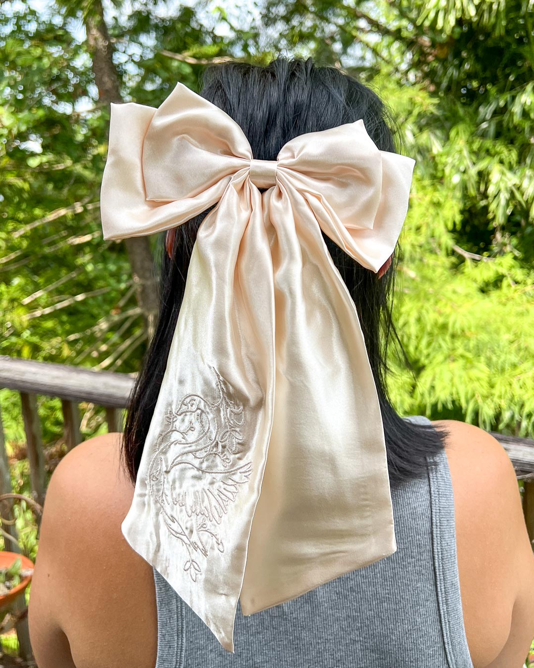 Lyndall Clipstone hair bow featuring a swan wrapped in ivy embroidered on the ivory satin for romantasy fans.