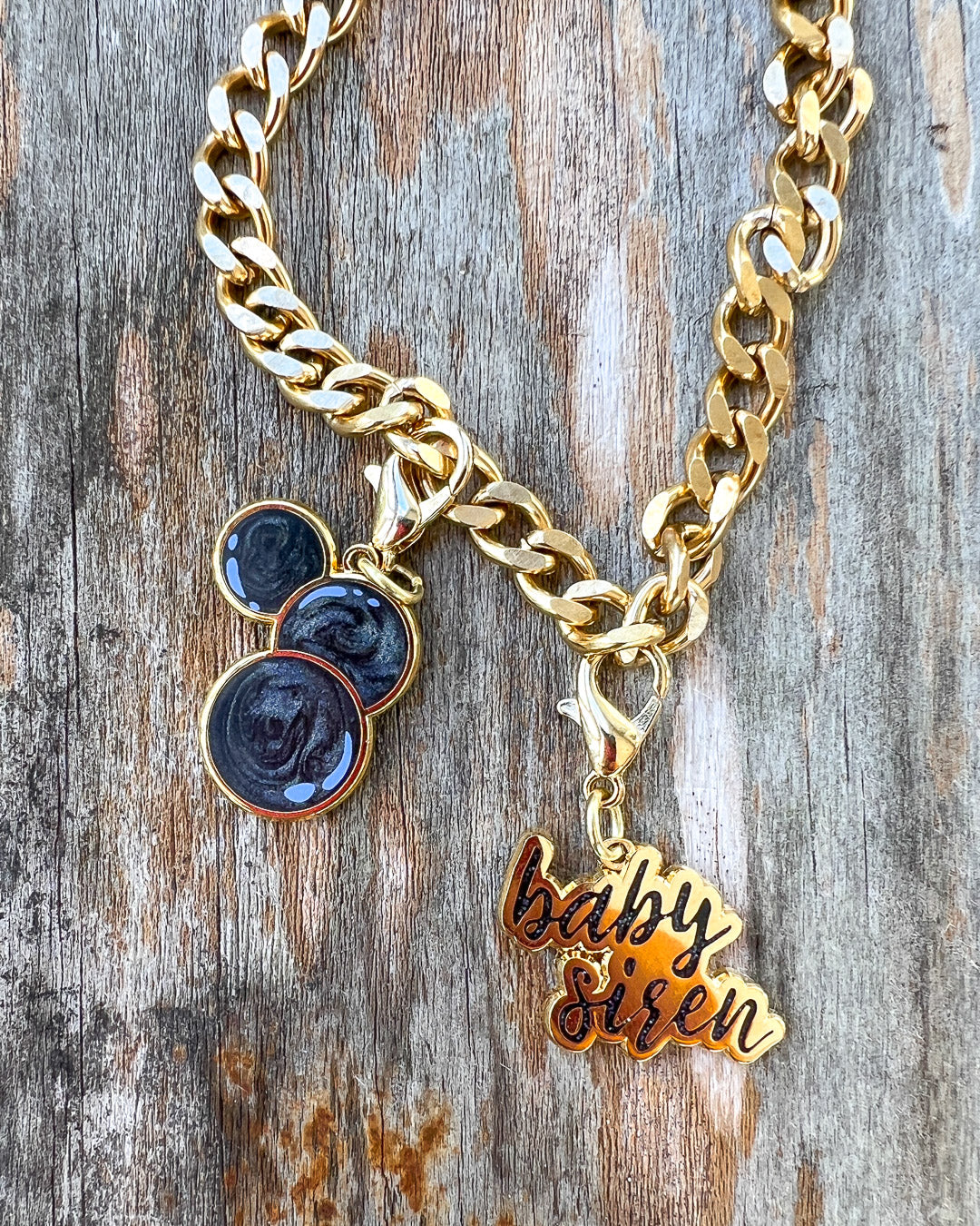 Laura Thalassa charm set for Bargainer fans featuring three swirling black beads and a gold &