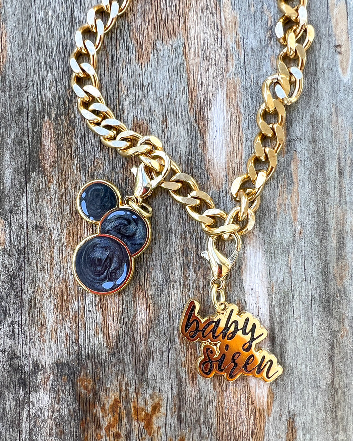 Laura Thalassa charm set for Bargainer fans featuring three swirling black beads and a gold &