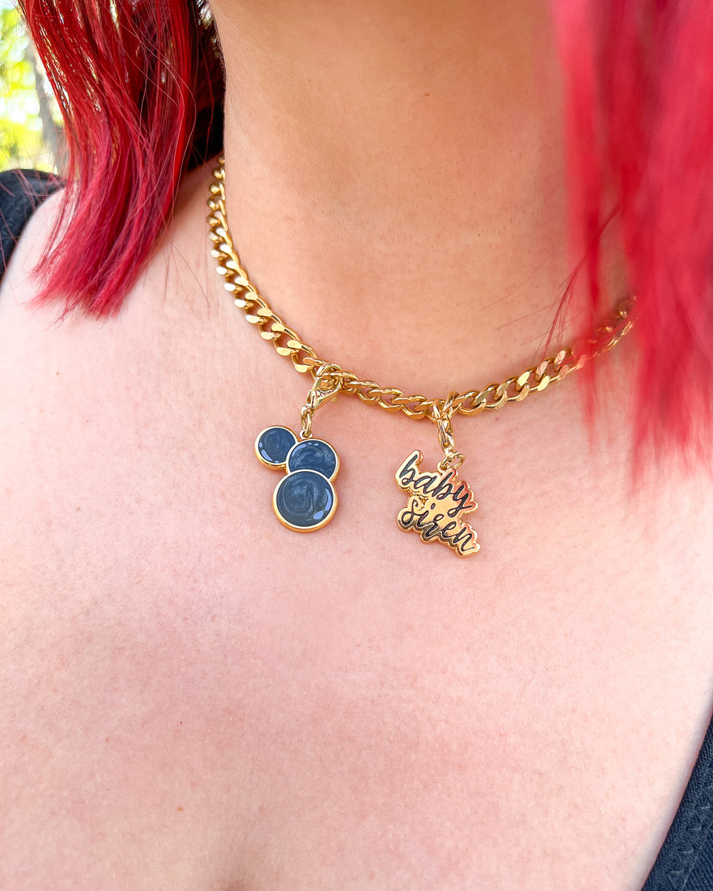 The Bargainer charms featuring three black beads and a 'baby siren' charm.