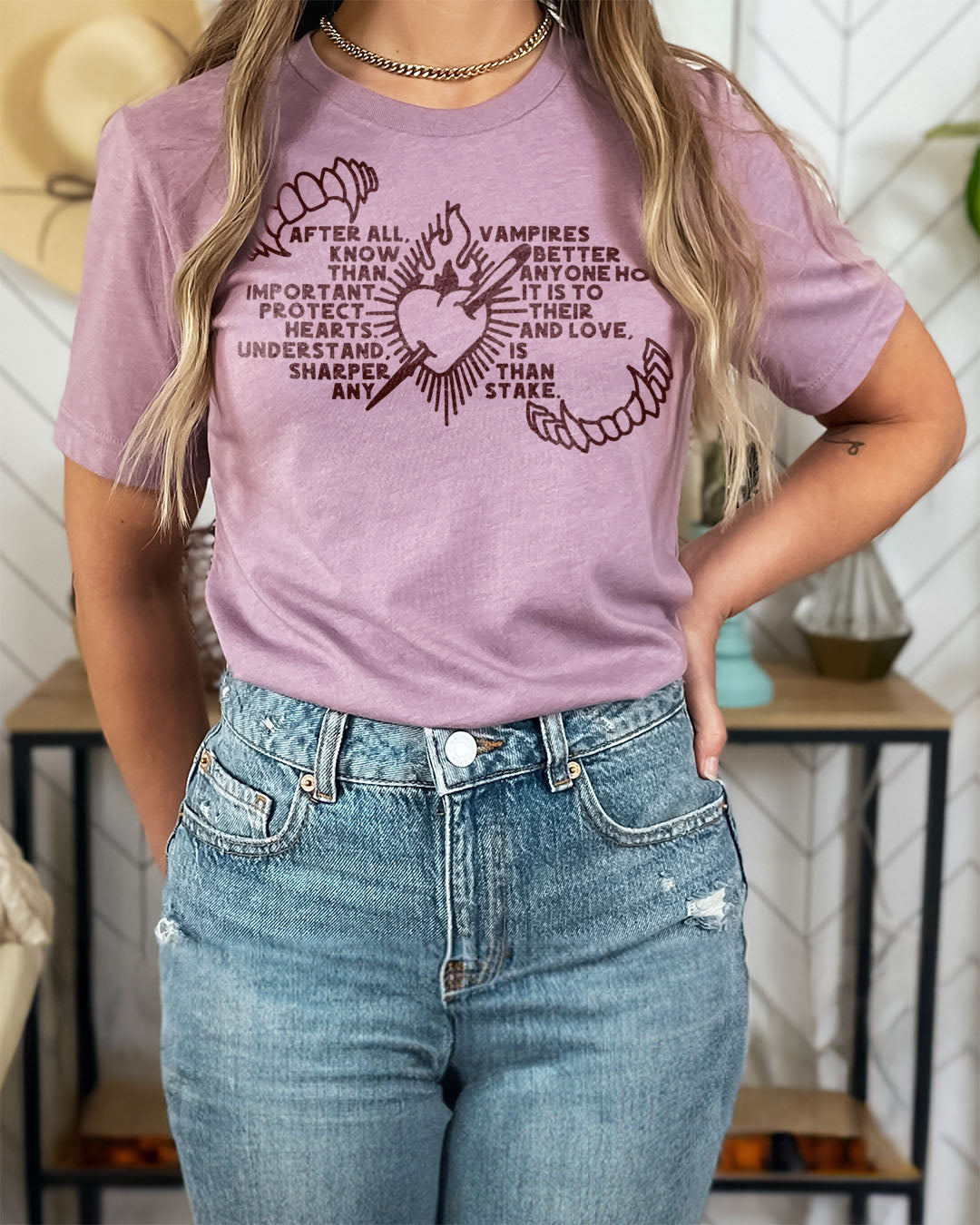 The Serpent and the Wings of Night shirt featuring fangs, a heart on fire speared with a stake, and the quote &