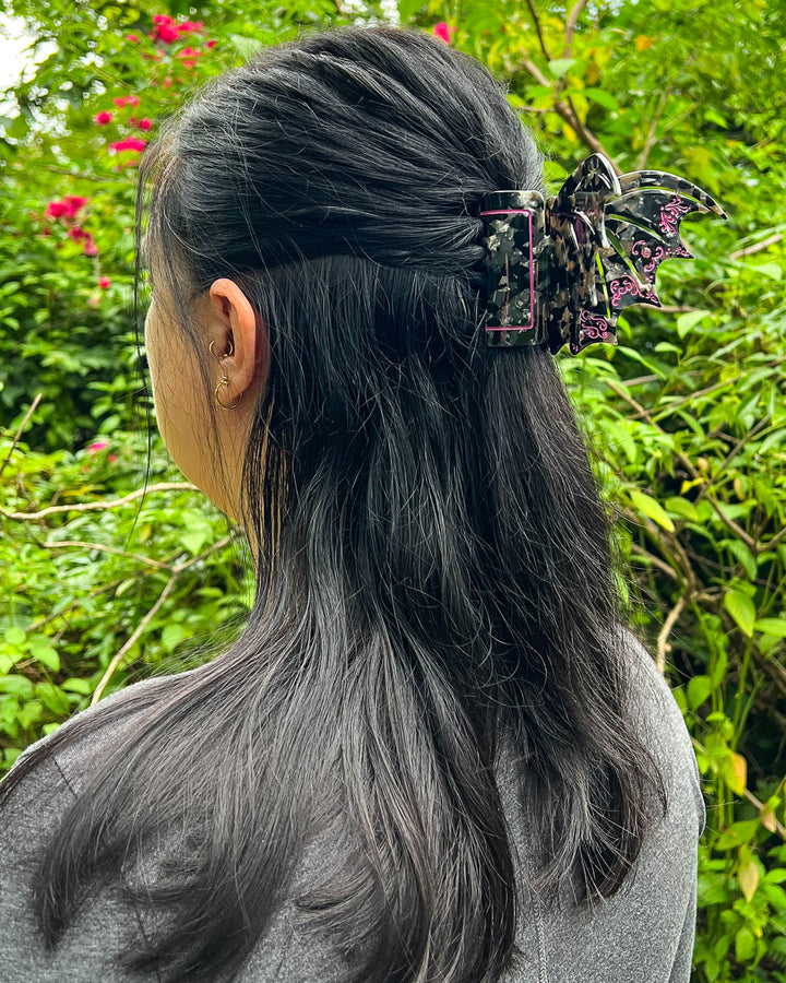 Bookish hair clip in violet and back with blue gem embellishments in the shape of bat wings inspired by ACOTAR.