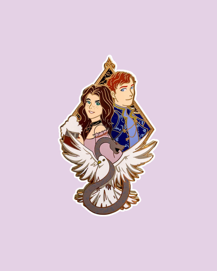 Serpent &amp; Dove enamel pin featuring Lou and Reid and a dove and snake coiled around each other in front of them.
