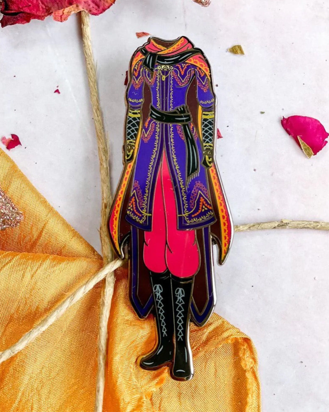 We Hunt the Flame pin featuring an illustrated design for Zafira&