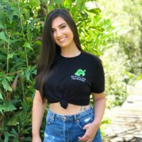 Girl wearing a black shirt with an embroidered design reading "did it all for the nookie".
