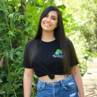 Girl wearing a black shirt with an embroidered design reading "did it all for the nookie".