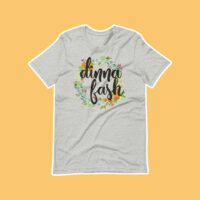 gray shirt on an orange background with a design reading "dinna fash".