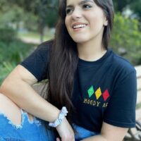 Girl wearing a black shirt with a design reading "moody AF"