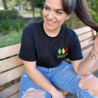Girl wearing a black shirt with a design reading "moody AF"