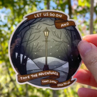 Sticker of the quote "let us go on and take the adventures that shall fall to us" from The Chronicles of Narnia